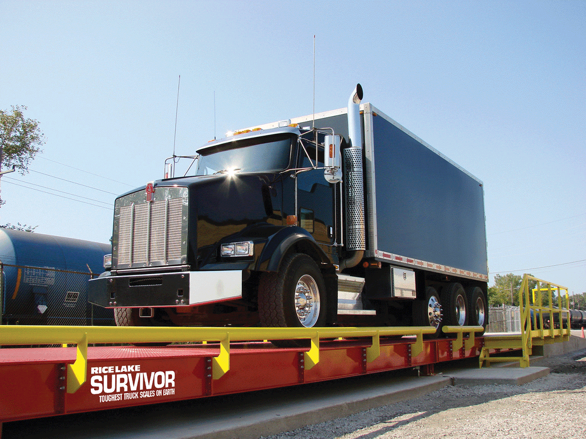 Large truck being weighed on a large industrial scale.