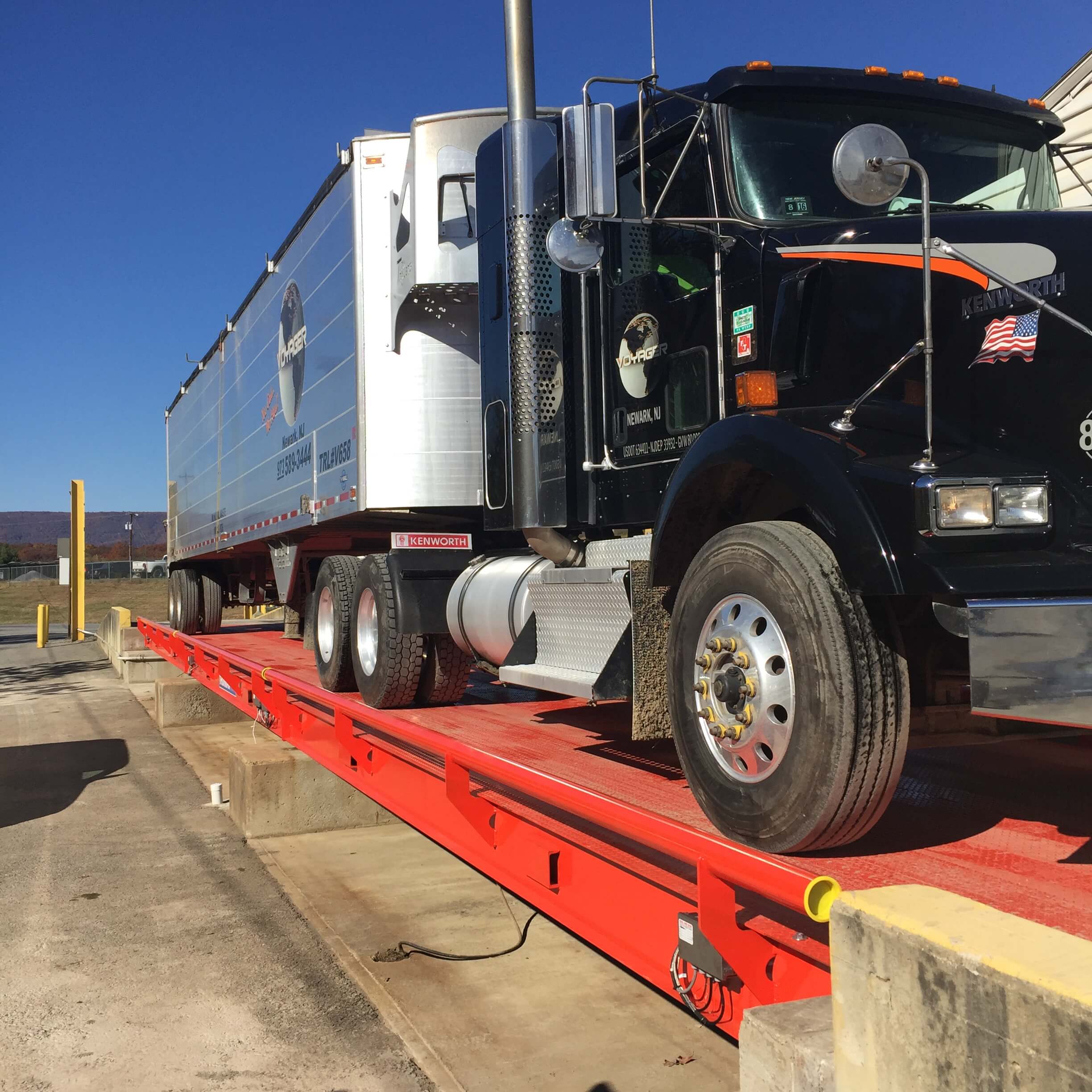 Large truck being weighed on a heavy capacity industrial truck scale.