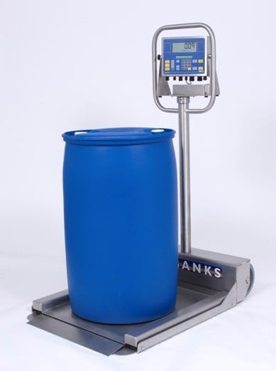 a blue barrel being weighed on a stainless steel barrel scale